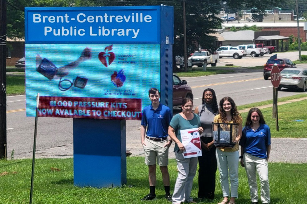 program participants in front of library sign