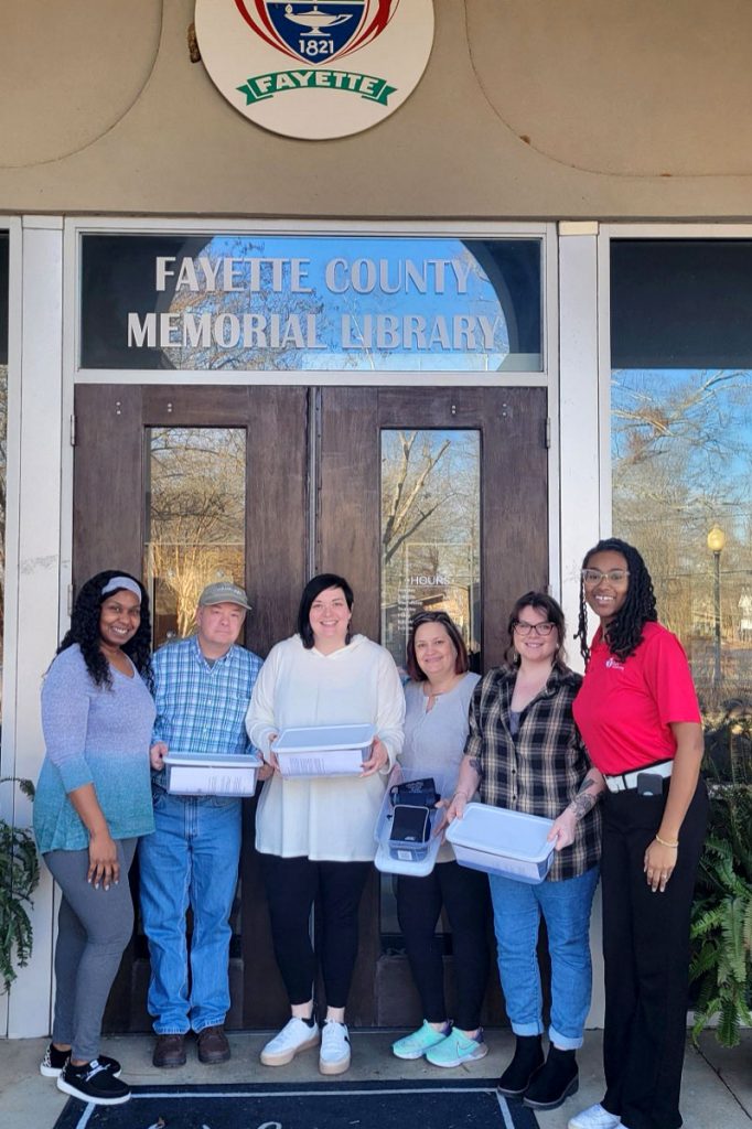 program participants in front of library sign
