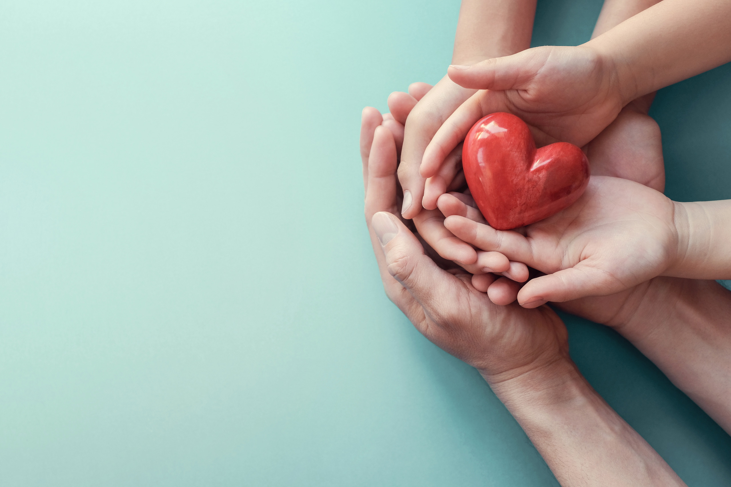 hands holding a ceramic heart
